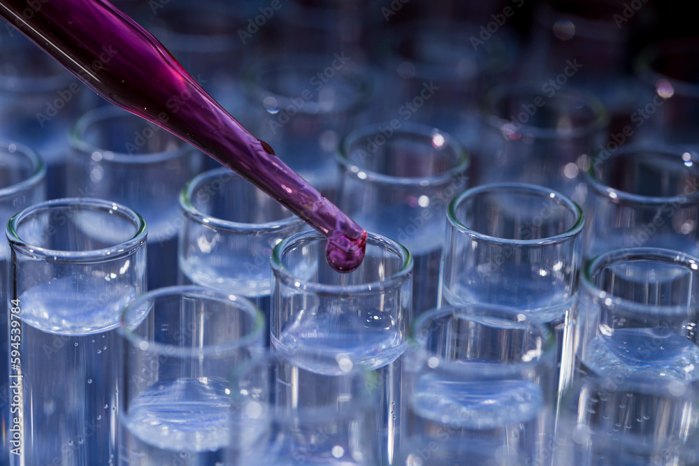 Pipette dropping fluid into test tube Pipette dropping fluid into test tube