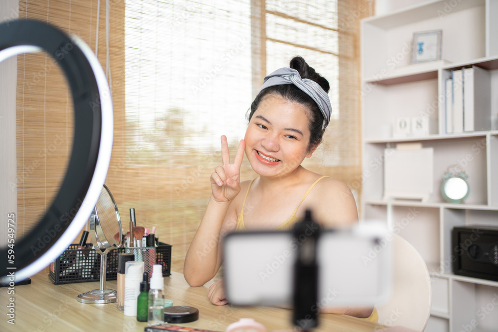 Beautiful woman with a social media influence is greeting the audience for recording vlog video live streaming, Showing how to make up and use cosmetics, Online business on concept of beauty bloggers. Beautiful woman with a social media influence is greeting the audience for recording vlog video live streaming, Showing how to make up and use cosmetics, Online business on concept of beauty bloggers.