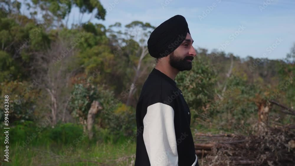 Indian Sikh Man Walking Outdoors And Enjoying Summer Nature - medium shot Indian Sikh Man Walking Outdoors And Enjoying Summer Nature - medium shot