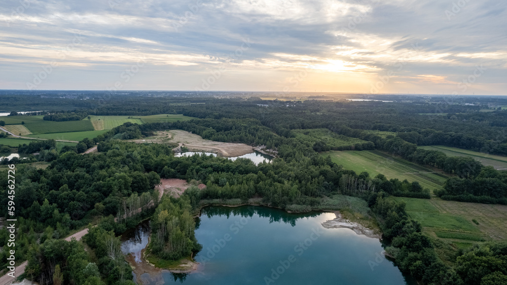 Aerial view panorama of green summer forest, corn fields and blue lake. Rural landscape. Drone photography from above. High quality photo