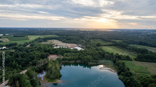 Aerial view panorama of green summer forest, corn fields and blue lake. Rural landscape. Drone photography from above. High quality photo