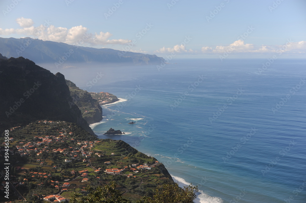 Picturesque view from the mountain on a village at the coastline of Atlantic Ocean on Madeira Island, Portugal