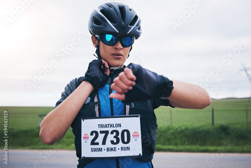 Obraz na płótnie Woman, cyclist and check heart rate on watch, timer and monitor health progress in triathlon race