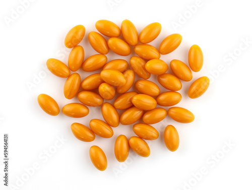 Oval orange capsules on a white background. Capsules in gelatin shell Q10 top view. Food supplement for brain activity. oval capsules with vitamins.