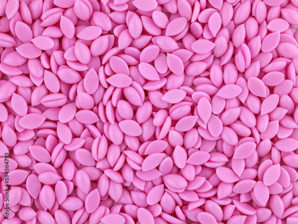 Beautiful granules of pink wax for depilation face arеa top view