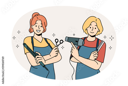 Working as hairdresser in salon concept. Two young smiling girls wearing aprons standing holding working tools in hairdressing salon vector illustration