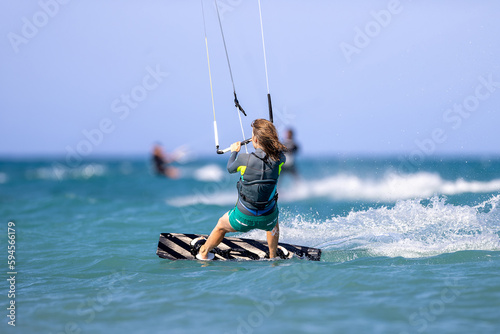 Kitesurfing girl in turquoise waters 