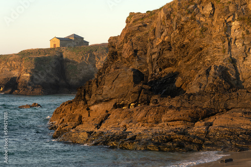 Santa Comba hermitage in the Santa Comba beach in the coast of Galicia at sunset in a sunny day. A Coruña, Spain.