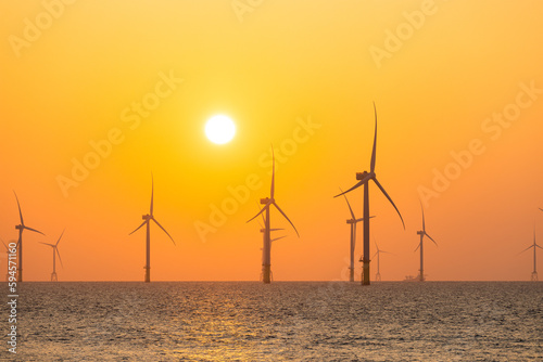 Wind turbine field over the sea in the evening