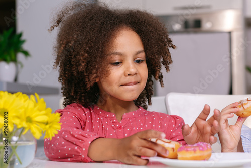 A black child eats sweets, dependence on sweets in children and adolescents.