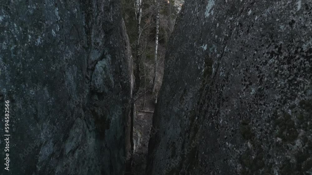 20m deep gorge in gray granite rock. Droneflight from above. 20m deep gorge in gray granite rock. Droneflight from above.