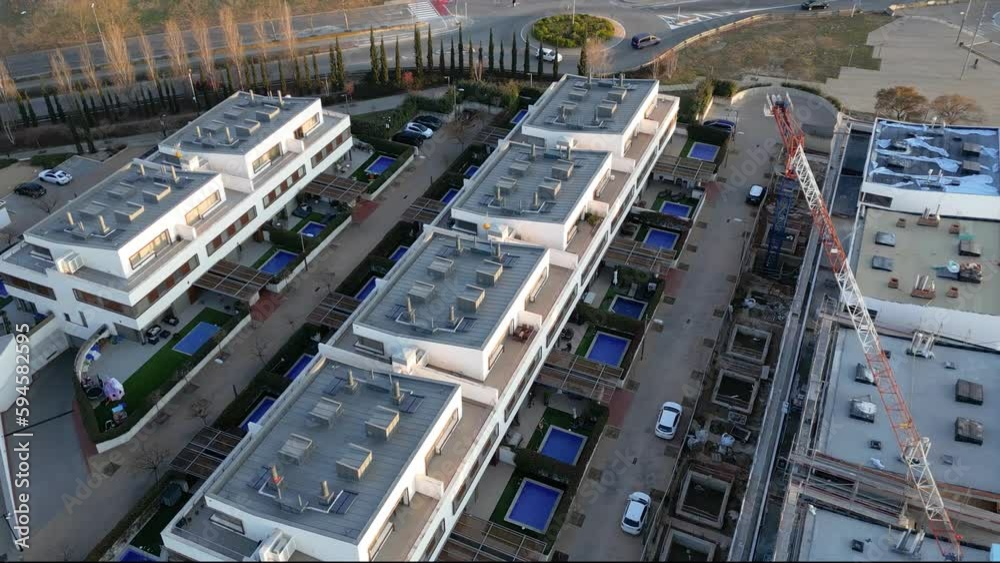 Aerial drone view over a residential area: modern real estate construction. Sustainable buildings in the suburb for a better future Aerial drone view over a residential area: modern real estate construction. Sustainable buildings in the suburb for a better future
