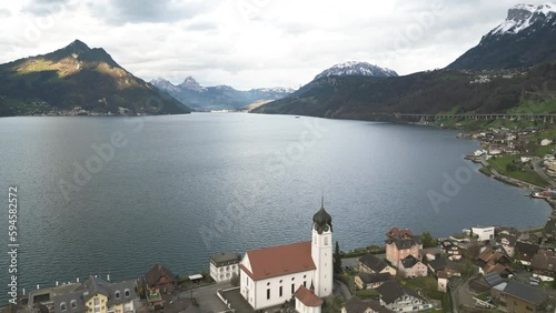 Aerial View of Lake Lucerne, Beckenried Village Church and Swiss Alps Hills, Drone Shot photo