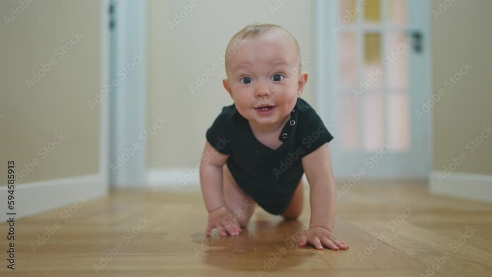 baby son crawling. happy family a first steps kid dream concept. baby newborn crawling down the hallway in the house. lifestyle happy baby boy crawling on the floor takes her first steps baby son crawling. happy family a first steps kid dream concept. baby newborn crawling down the hallway in the house. lifestyle happy baby boy crawling on the floor takes her first steps