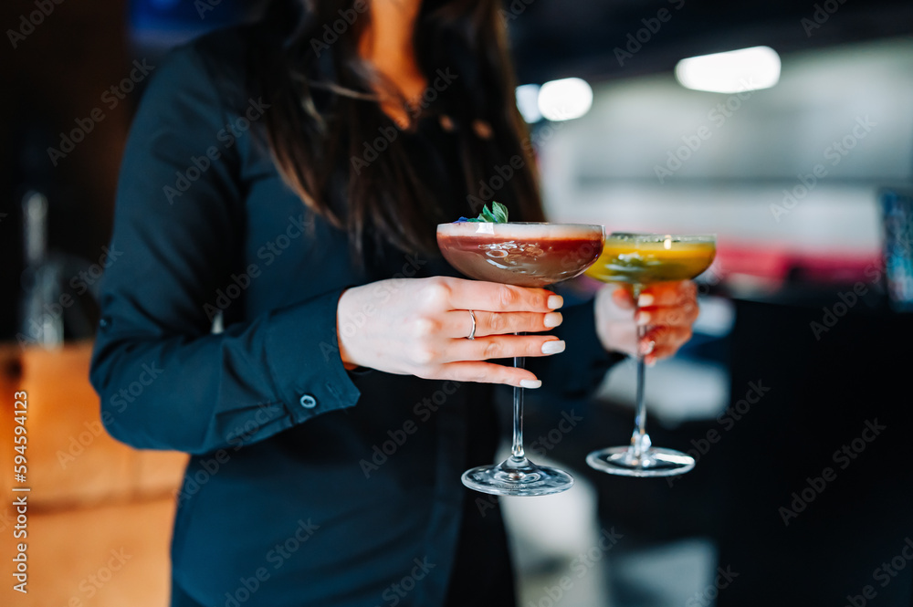young woman waitress with cocktail drinks at restaurant
