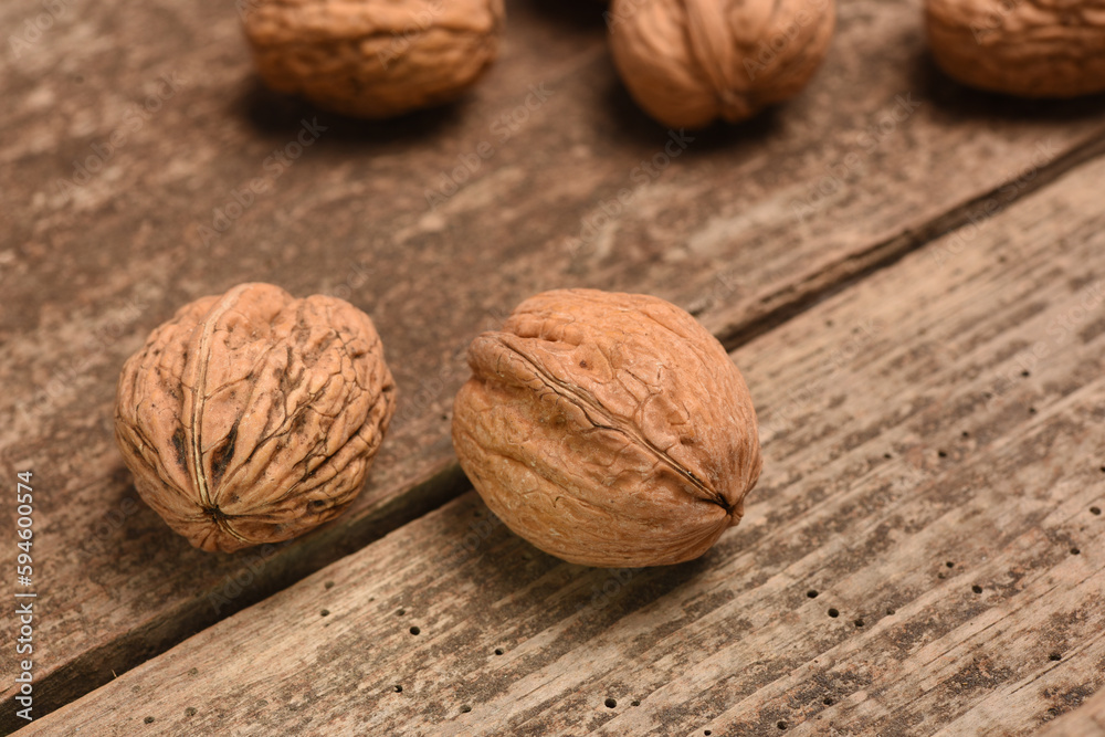 walnuts lying on an old wooden board walnuts lying on an old wooden board