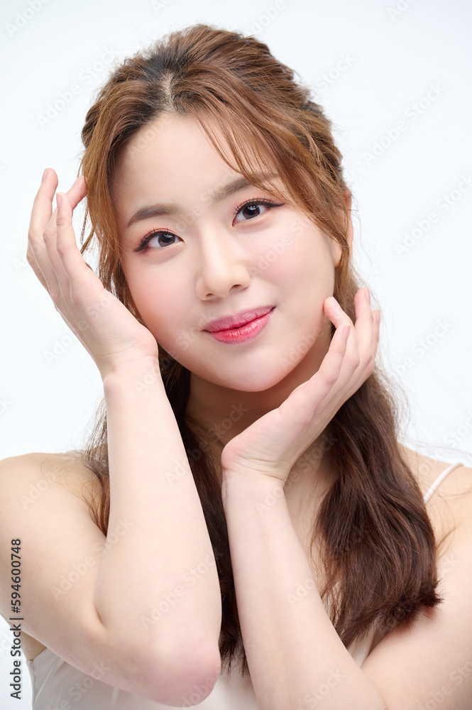 Beautiful Young Asian woman with clean fresh skin touching two hands on face in beauty pose. Pretty girl smiling in white background. Facial treatment, cosmetology, cosmetic surgery, make up concept. Beautiful Young Asian woman with clean fresh skin touching two hands on face in beauty pose. Pretty girl smiling in white background. Facial treatment, cosmetology, cosmetic surgery, make up concept.