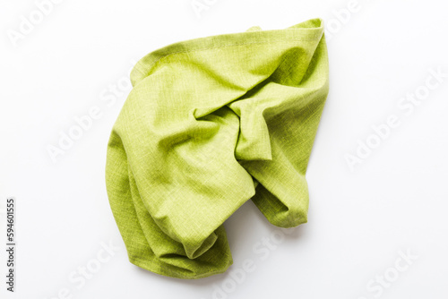 top view with green kitchen napkin isolated on table background. Folded cloth for mockup with copy space, Flat lay. Minimal style