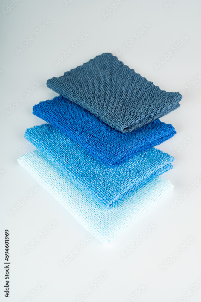 A pile of colorful soft microfiber towels on a white table A pile of colorful soft microfiber towels on a white table