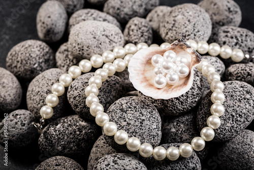 Pearl necklaces on grey stones