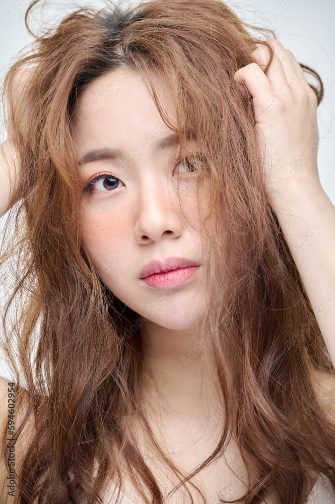 Beautiful Young Asian woman with clean fresh skin touching two hands on face in beauty pose. Pretty girl smiling in white background. Facial treatment, cosmetology, cosmetic surgery, make up concept. Beautiful Young Asian woman with clean fresh skin touching two hands on face in beauty pose. Pretty girl smiling in white background. Facial treatment, cosmetology, cosmetic surgery, make up concept.