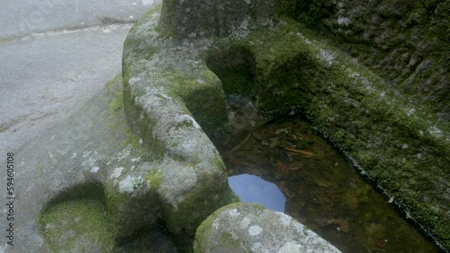 anthropomorphic tomb san pedro de rocas monastery, esgos, spain, filled with moss and water photo