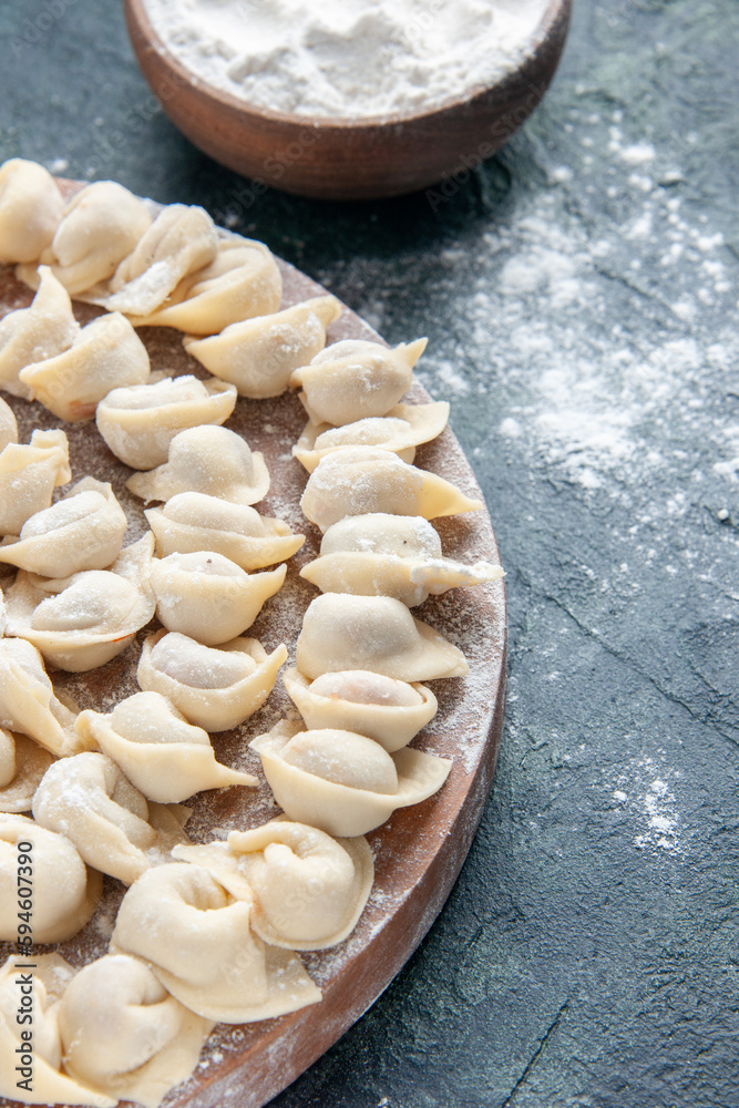 front view little dumplings with flour on dark background dough color food calorie meal food dish meat front view little dumplings with flour on dark background dough color food calorie meal food dish meat