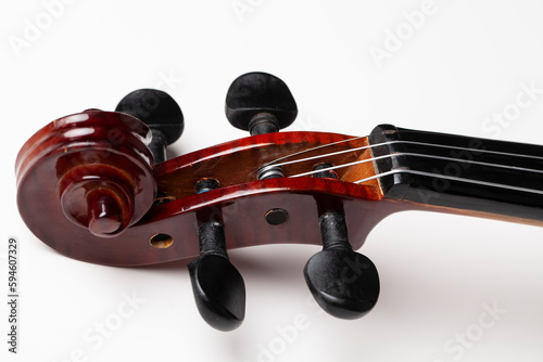 Violin on studio background. String stretching process. photo
