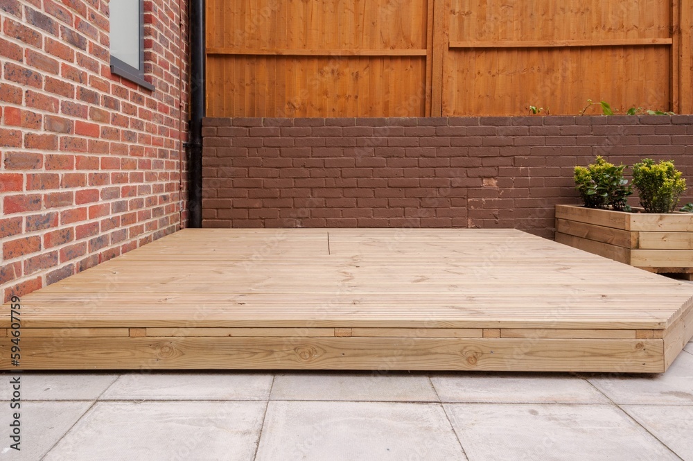 Newly built wooden deck in back garden. - obrazy, fototapety, plakaty 
