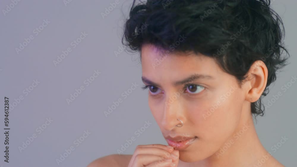 CU Studio shot of woman touching face