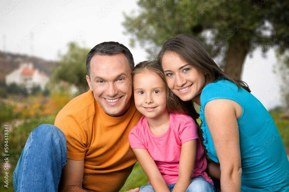 Happy young parents with cute child walking outdoors Happy young parents with cute child walking outdoors