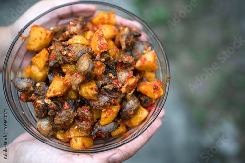 a bowl of sambal from chicken liver and potato wedges