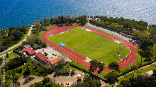 Aerial view of the sports facility with the running track that is located in Virgiliano park, also called Park of Remembrance, a park located on the hill of Posillipo, Naples, Italy. It overlooks sea. photo