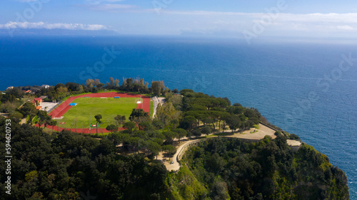 Aerial view of the sports facility with the running track that is located in Virgiliano park, also called Park of Remembrance, a park located on the hill of Posillipo, Naples, Italy. It overlooks sea.