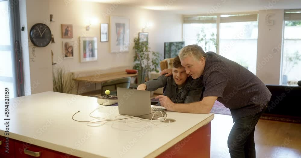 WS Father with disabled son using laptop at home WS Father with disabled son using laptop at home
