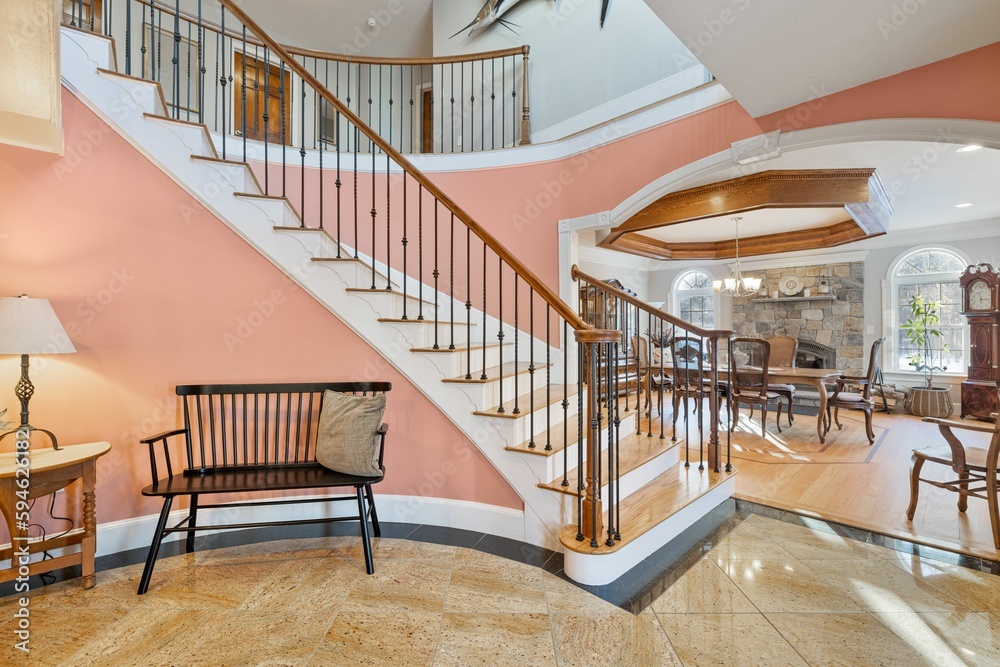 Obraz premium Two-story house, featuring a staircase connecting the ground floor to the second story