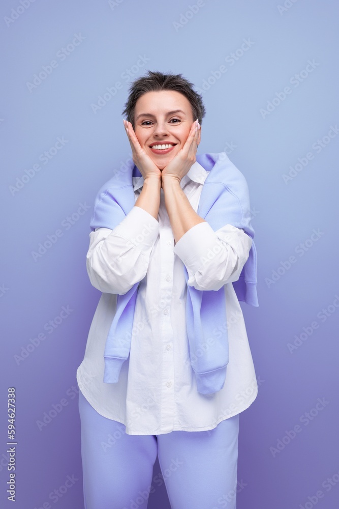 vertical photo of a stylish fashionable young lady with tousled hair in a white shirt in an informal setting vertical photo of a stylish fashionable young lady with tousled hair in a white shirt in an informal setting