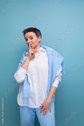 energetic charismatic short-haired lady in a casual shirt makes a grimace