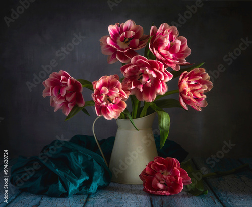 Still life with beautiful red-white tulips and a jug.