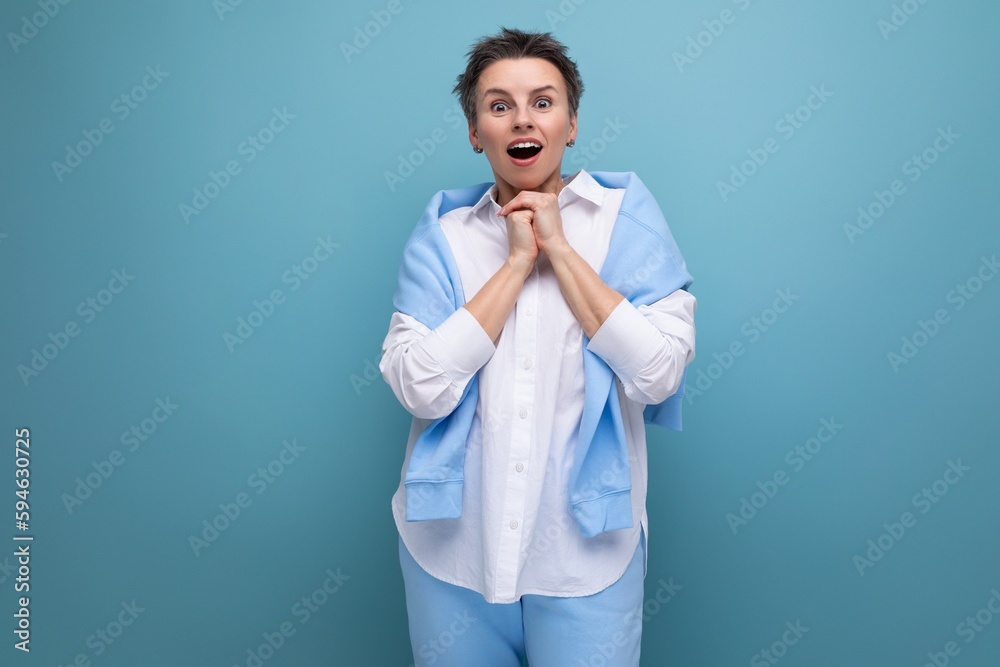 shocked surprised young brunette woman with short haircut in white shirt