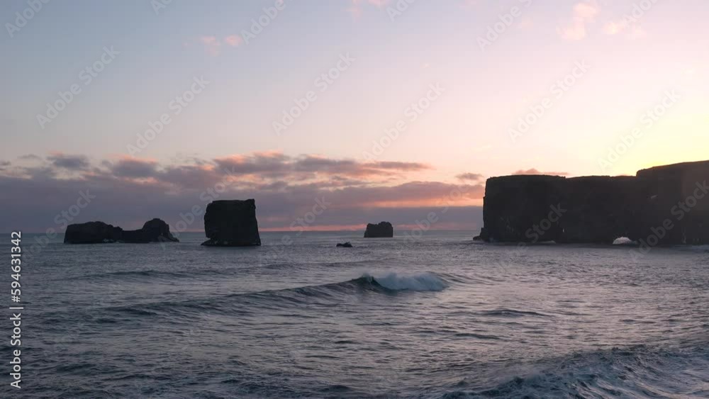 Iceland. Beautiful landscape with ocean waves on a winter beach. Picturesque view of dramatic panorama to endless ocean black volcanic sand beach from Dyrholaey Cape. Iceland. Beautiful landscape with ocean waves on a winter beach. Picturesque view of dramatic panorama to endless ocean black volcanic sand beach from Dyrholaey Cape.