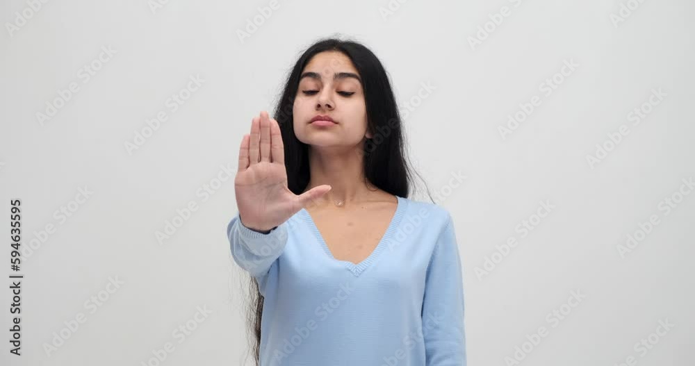 Annoyed woman showing stop gesture with palm of her hand Annoyed woman showing stop gesture with palm of her hand