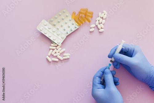 Syringe doctor s hands with assorted pills
