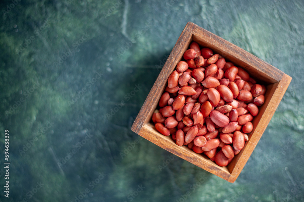 top view peeled clean peanuts on dark-blue background shell nut walnut peanut color snack cips - obrazy, fototapety, plakaty 