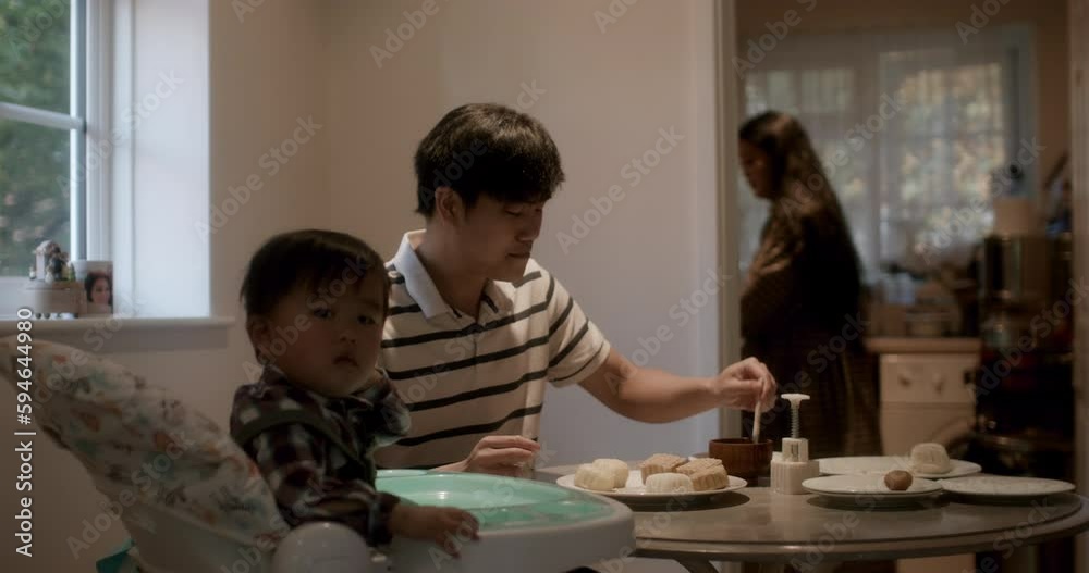 MS Parents with son (18-23 months) making moon cakes at home MS Parents with son (18-23 months) making moon cakes at home