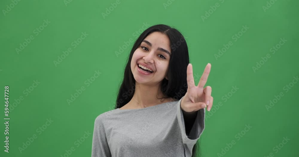 Portrait of happy woman giving v sign using both the hands Portrait of happy woman giving v sign using both the hands