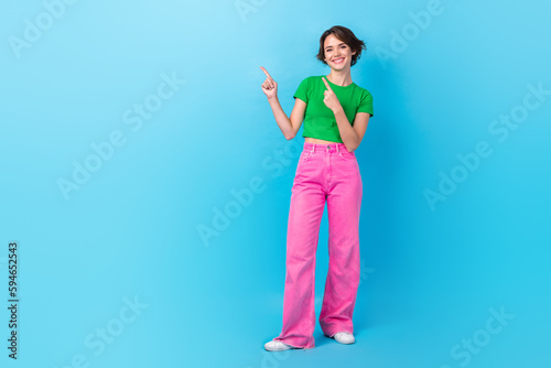 Full length photo of model wear green t-shirt pink pants direct fingers empty space new zara boutiques promo isolated on cyan color background © deagreez