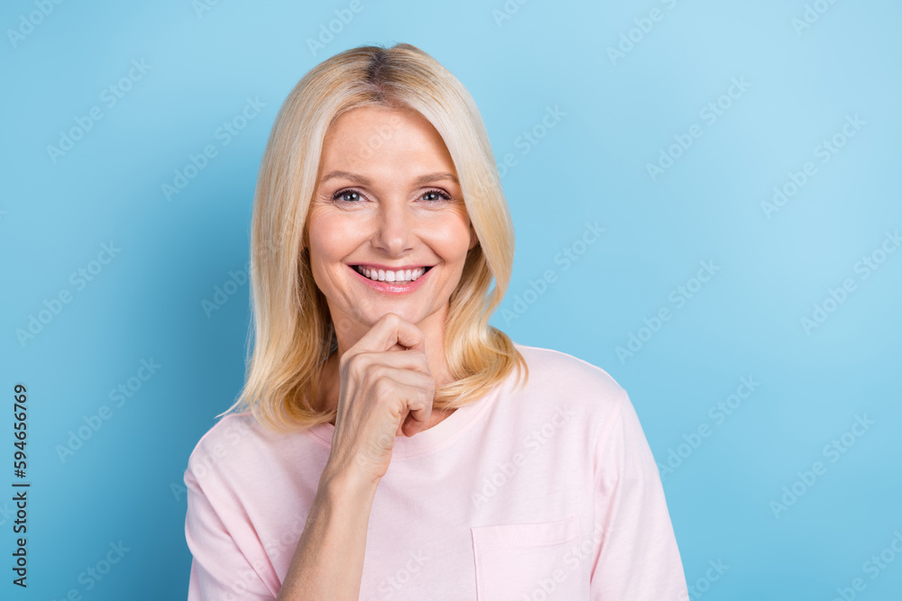 Photo of cheerful positive person with bob hairstyle dressed white t-shirt finger on chin dental ad isolated on blue color background Photo of cheerful positive person with bob hairstyle dressed white t-shirt finger on chin dental ad isolated on blue color background