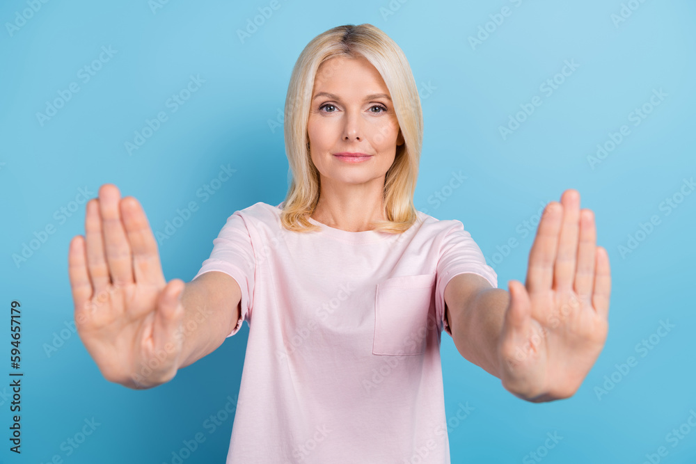 Portrait of aged concentrated person hands palms demonstrate block rejection gesture isolated on blue color background