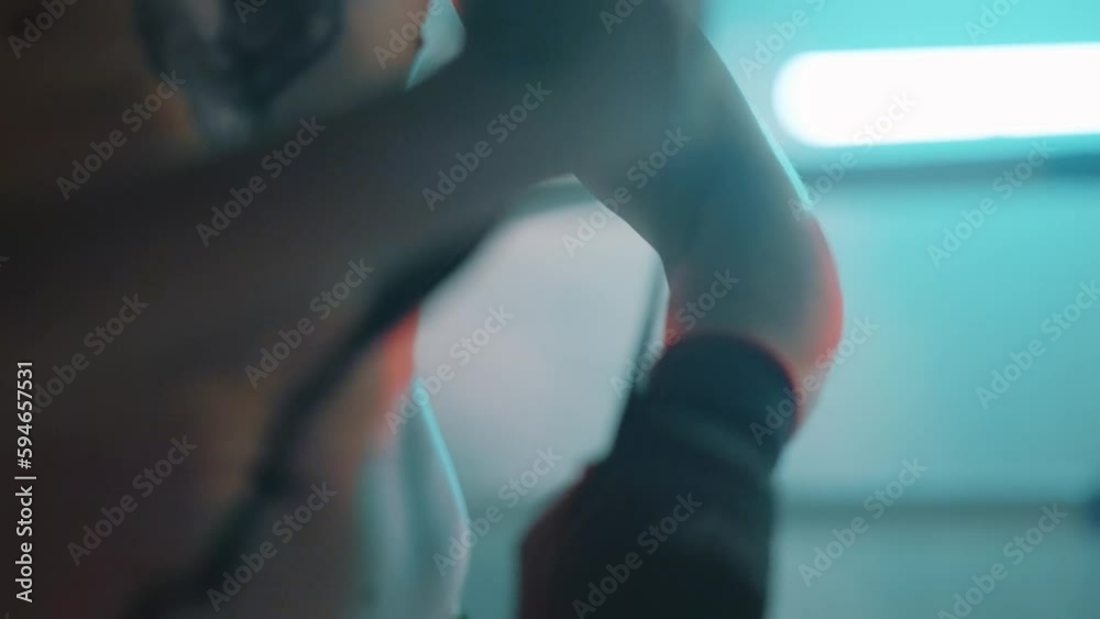 Muscular Caucasian bearded boxer man with tattoos putting on straps preparing for combat Muscular Caucasian bearded boxer man with tattoos putting on straps preparing for combat